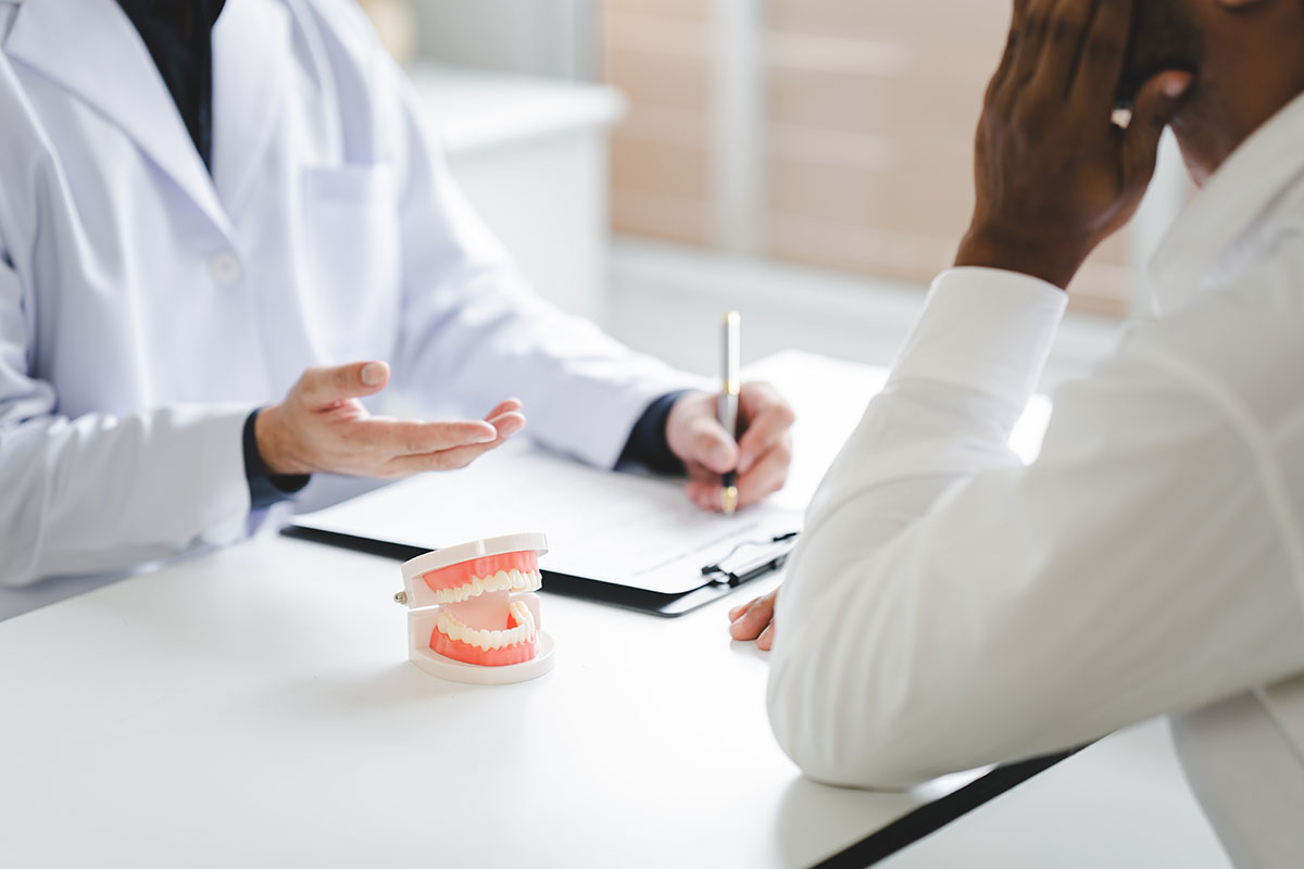 Patient listening to doctor explain treatment options during free orthodontic consultation Davis