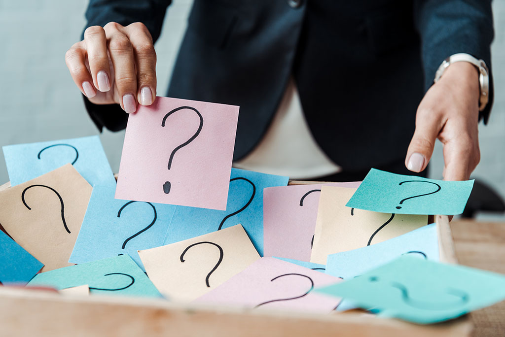 man picking up questions Asking quesetions during a consult helps patients choose a great orthodontist for them.