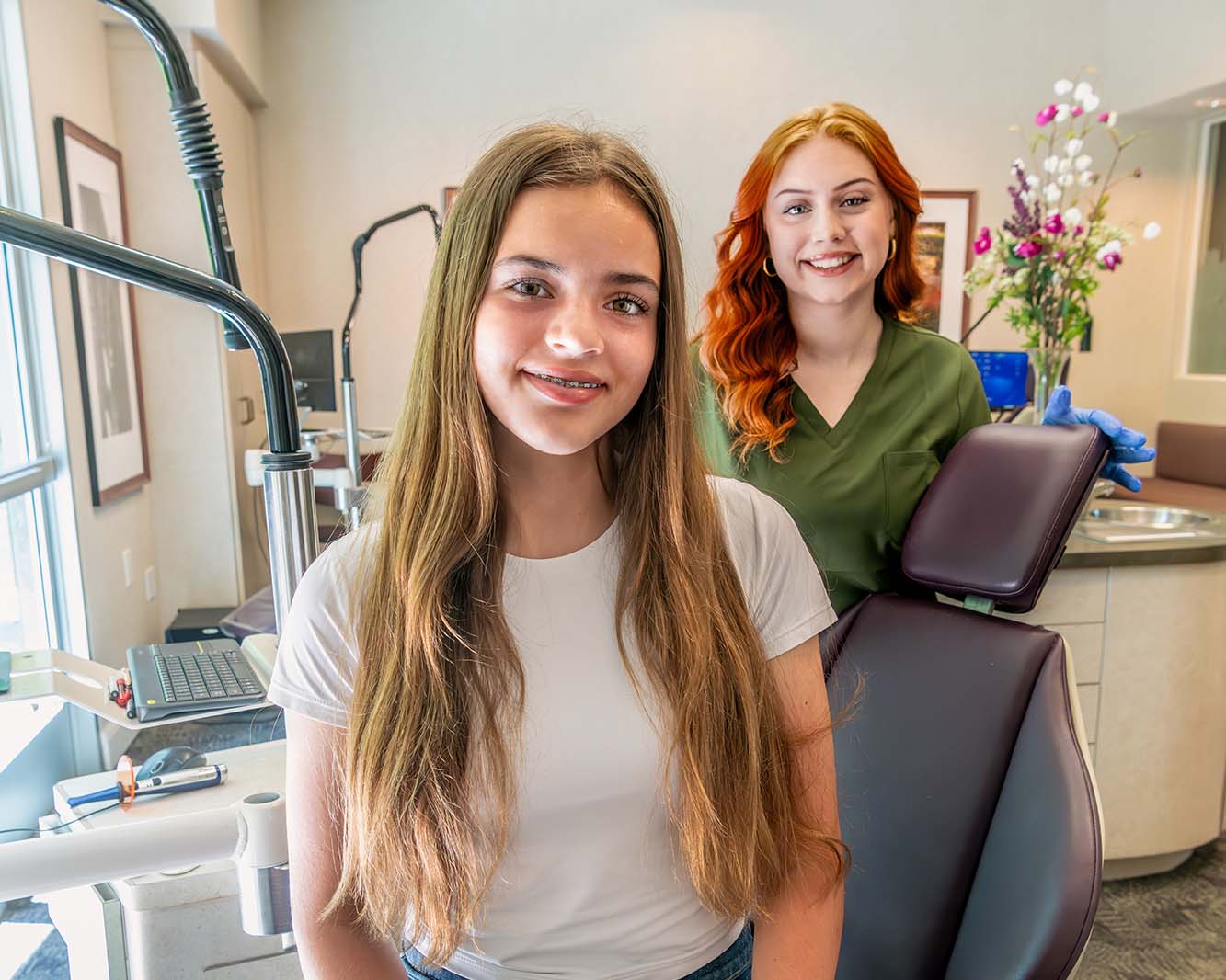 Teen girl with a confident smile, showing her braces for teens treatment at Kelleher Orthodontics.